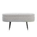 Banc de rangement capitonné ovale, couvercle à charnière, tissu polyester, rembourrage en mousse, pieds fuselés en métal noir, capuchons dorés pour les pieds