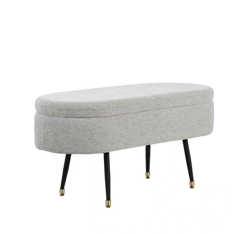 Banc de rangement capitonné ovale, couvercle à charnière, tissu polyester, rembourrage en mousse, pieds fuselés en métal noir, capuchons dorés pour les pieds
