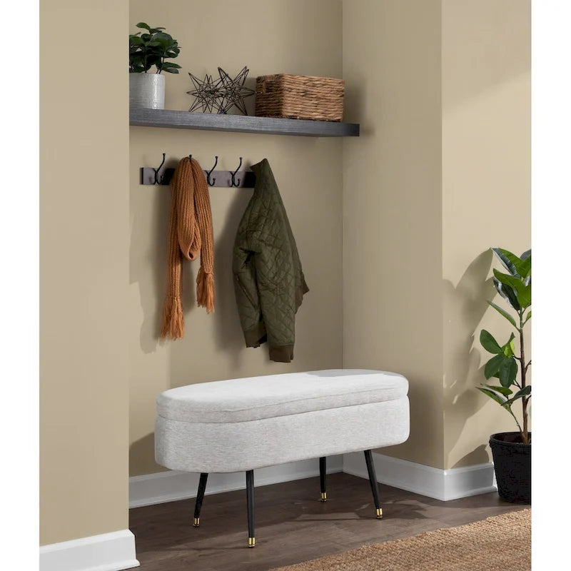 Banc de rangement capitonné ovale, couvercle à charnière, tissu polyester, rembourrage en mousse, pieds fuselés en métal noir, capuchons dorés pour les pieds